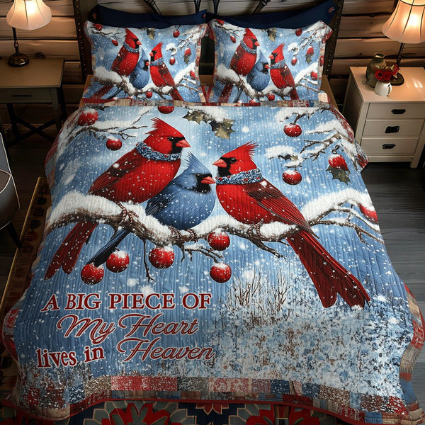 Snowy Cardinal quilted 3-piece bedding set on a made bed with two matching pillow shams