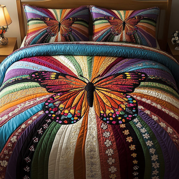 Spectrum Wings quilted 3-piece bedding set on a made bed with two matching pillow shams