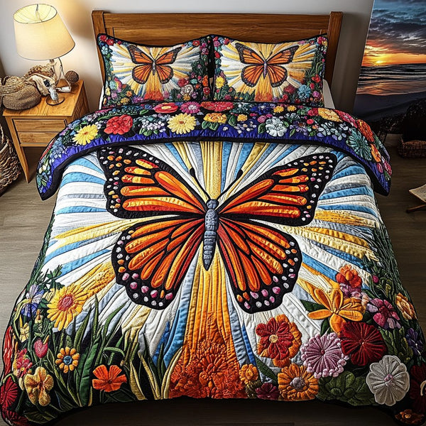 Sunlit Butterfly quilted 3-piece bedding set on a made bed with two matching pillow shams