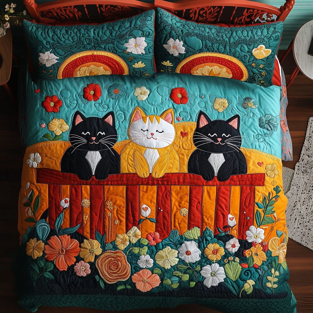 Sunset Fence Cats quilted 3-piece bedding set on a made bed with two matching pillow shams