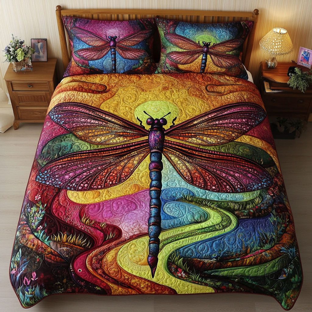 Sunset Wings quilted 3-piece bedding set on a made bed with two matching pillow shams