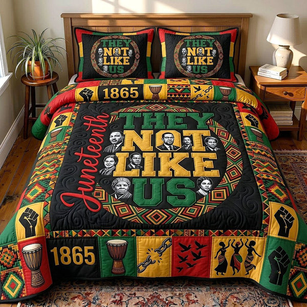 They Not Like Us quilted 3-piece bedding set on a made bed with two matching pillow shams