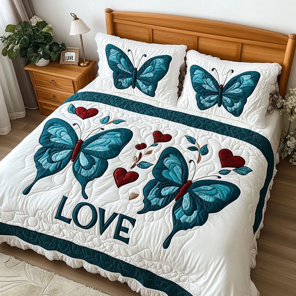 Transformative Love quilted 3-piece bedding set on a made bed with two matching pillow shams