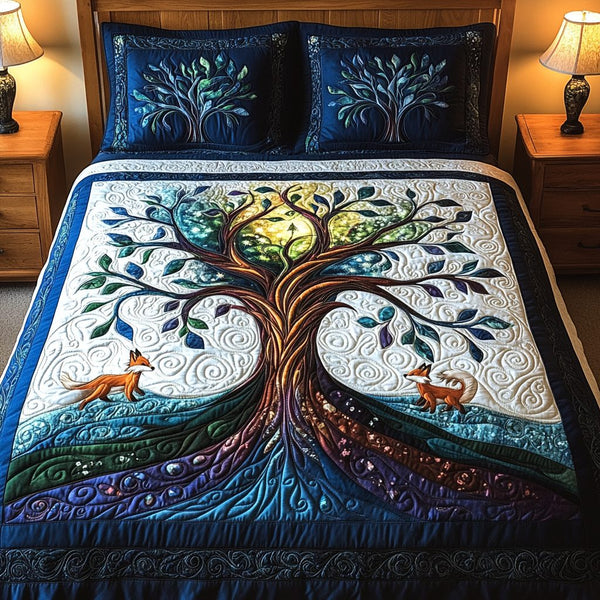 Tree of Tranquility quilted 3-piece bedding set on a made bed with two matching pillow shams