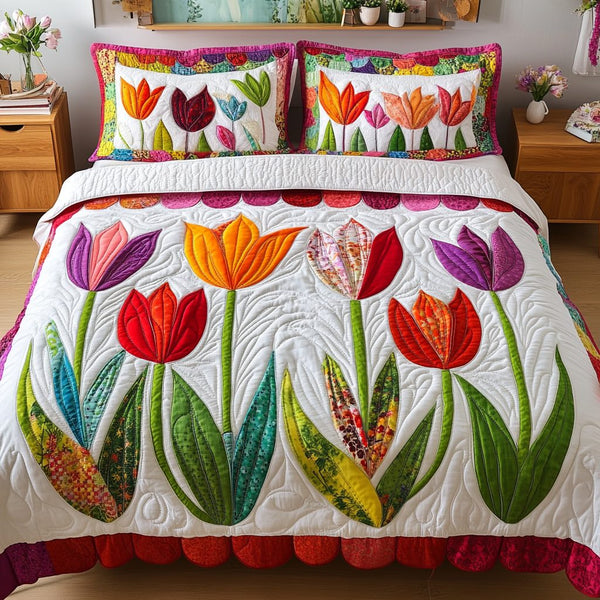 Tulip Dreams quilted 3-piece bedding set on a made bed with two matching pillow shams