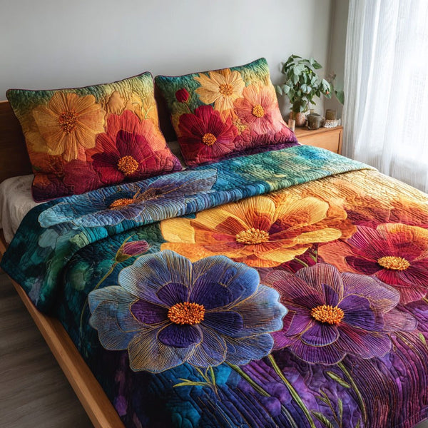 Velvet Blooms quilted 3-piece bedding set on a made bed with two matching pillow shams