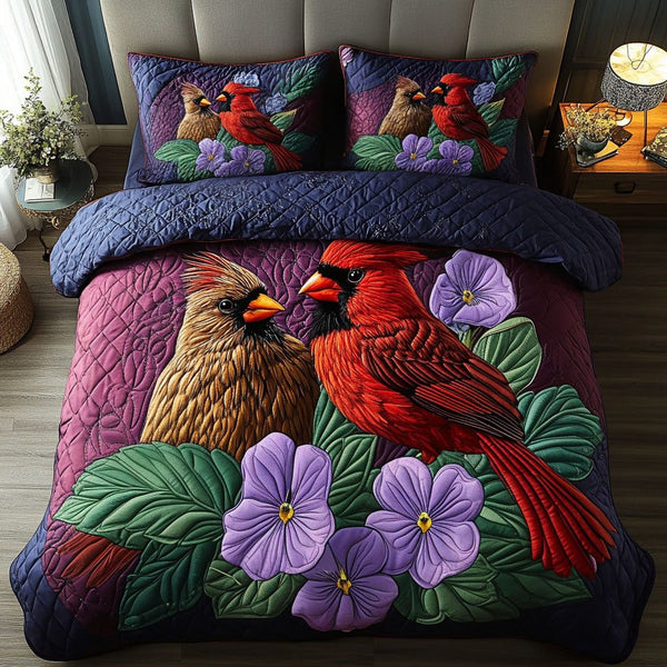Violet Cardinals quilted 3-piece bedding set on a made bed with two matching pillow shams