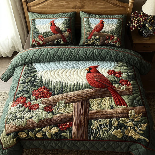 Whispering Cardinal quilted 3-piece bedding set on a made bed with two matching pillow shams