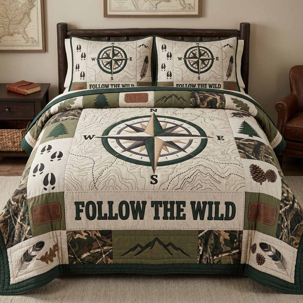 Wild Compass quilted 3-piece bedding set on a made bed with two matching pillow shams