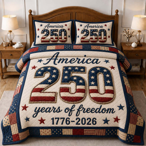 America 250 Anniversary quilted 3-piece bedding set on a made bed in a warmly lit bedroom