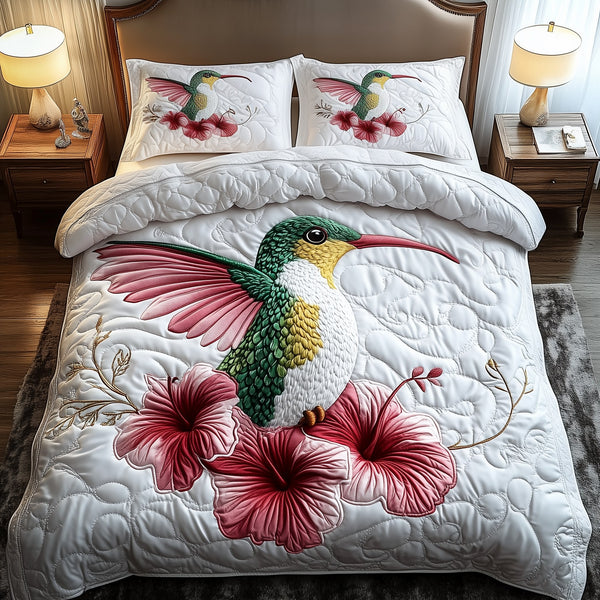 Charming Hummingbird quilted 3-piece bedding set on a made bed with two matching pillow shams