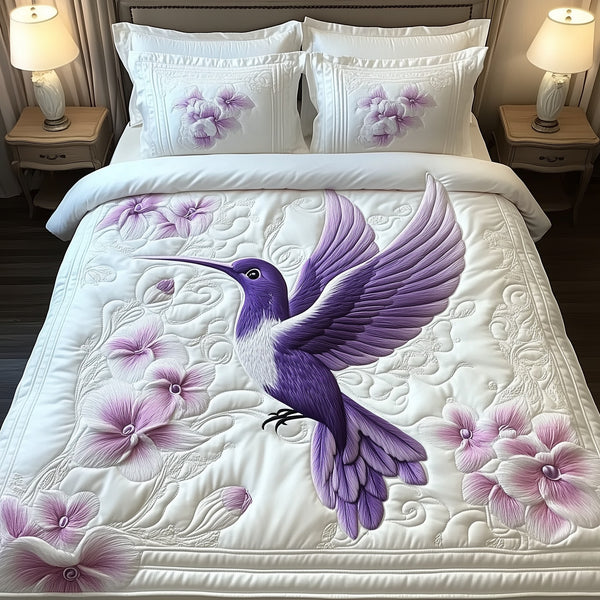 Charming Hummingbird quilted 3-piece bedding set on a made bed with two matching pillow shams