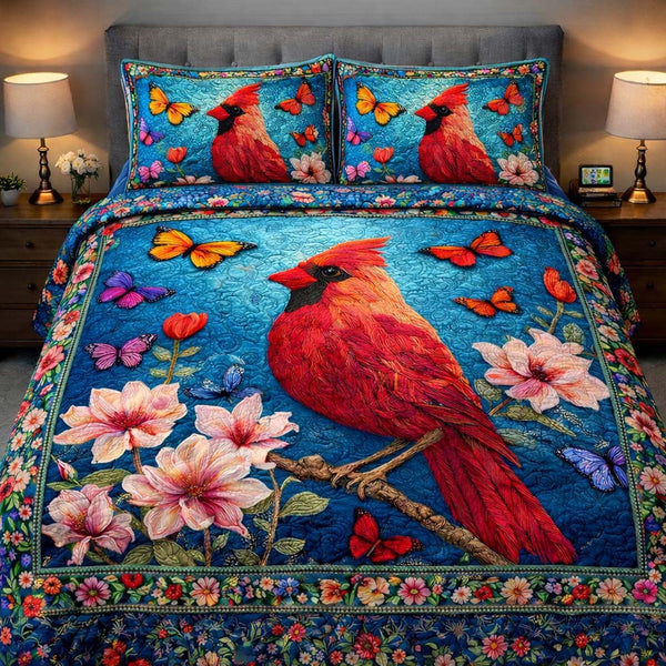Azure Cardinal Garden quilted 3-piece bedding set on a made bed with two matching pillow shams
