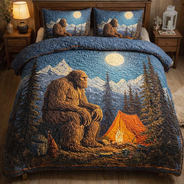 Campfire Mountain Bigfoot quilted 3-piece bedding set on a made bed with two matching pillow shams