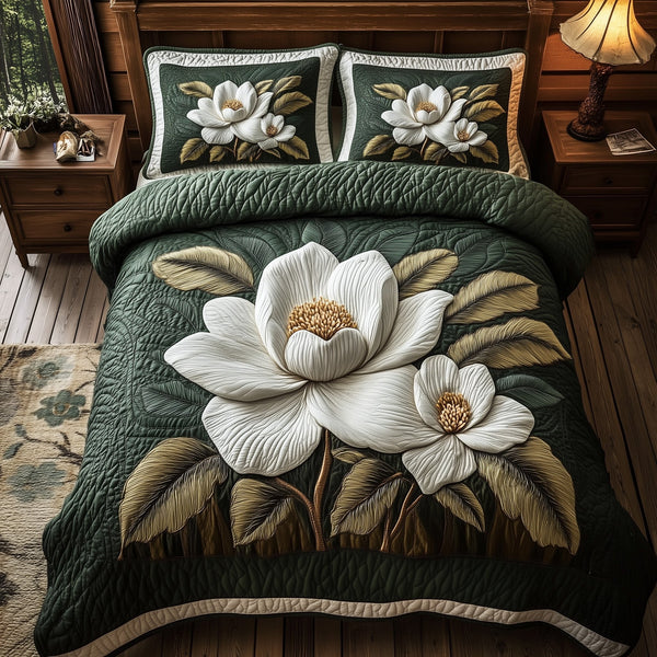 Delicate Magnolia Whisper quilted 3-piece bedding set on a made bed with two matching pillow shams