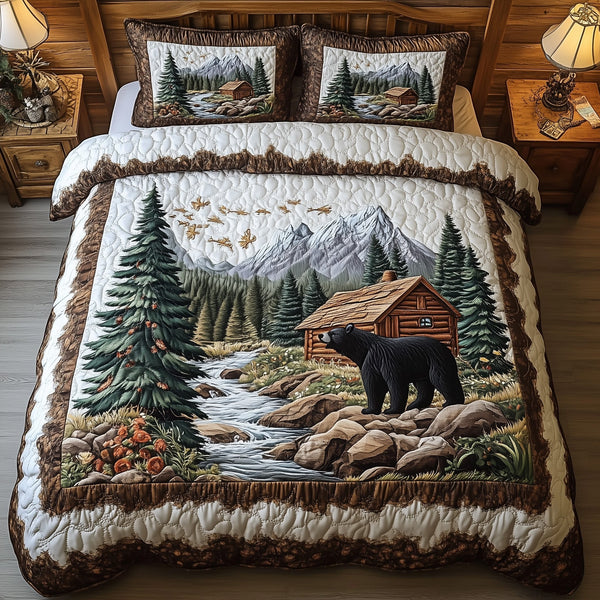 Bear and Cabin quilted 3-piece bedding set on a made bed with two matching pillow shams