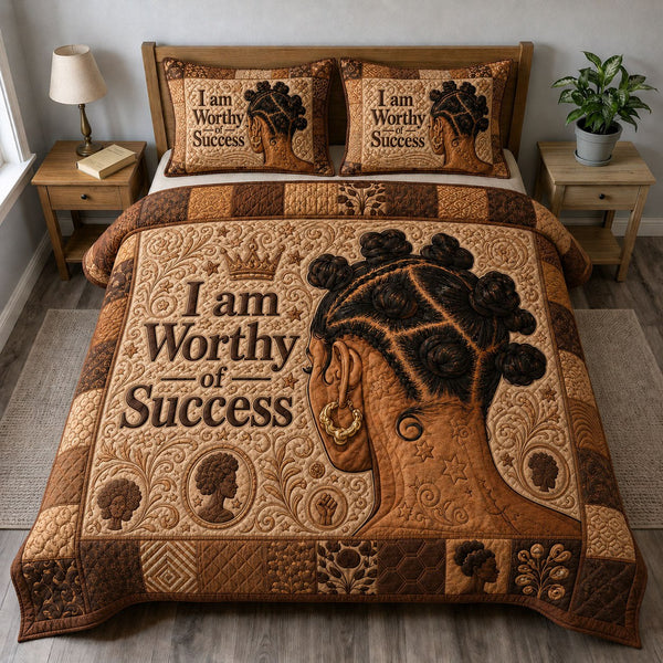 Empowered Queen Affirmation quilted 3-piece bedding set on a made bed with two matching pillow shams