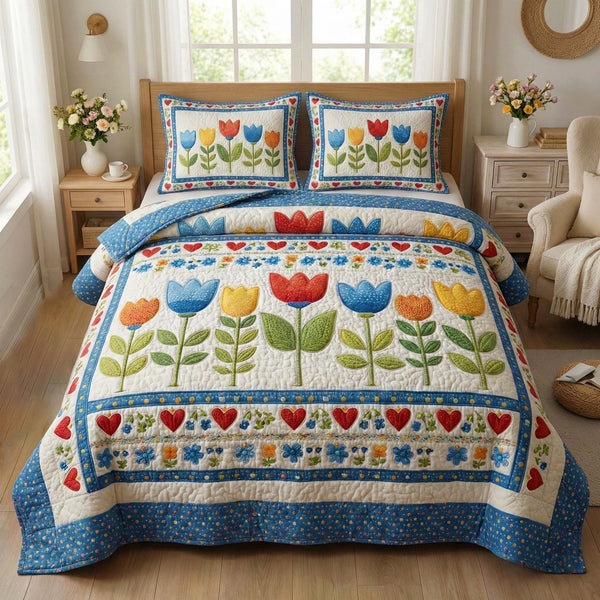 Blossom Grace quilted 3-piece bedding set on a made bed with two matching pillow shams