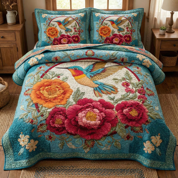 Blossom Grace quilted 3-piece bedding set on a made bed with two matching pillow shams