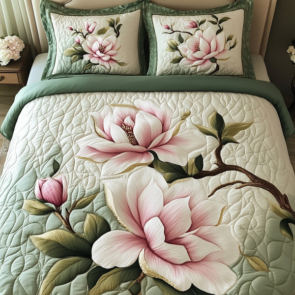 Elegant Blooming Magnolia quilted 3-piece bedding set on a made bed with two matching pillow shams