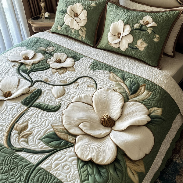 Elegant Blooming Magnolia quilted 3-piece bedding set on a made bed with two matching pillow shams