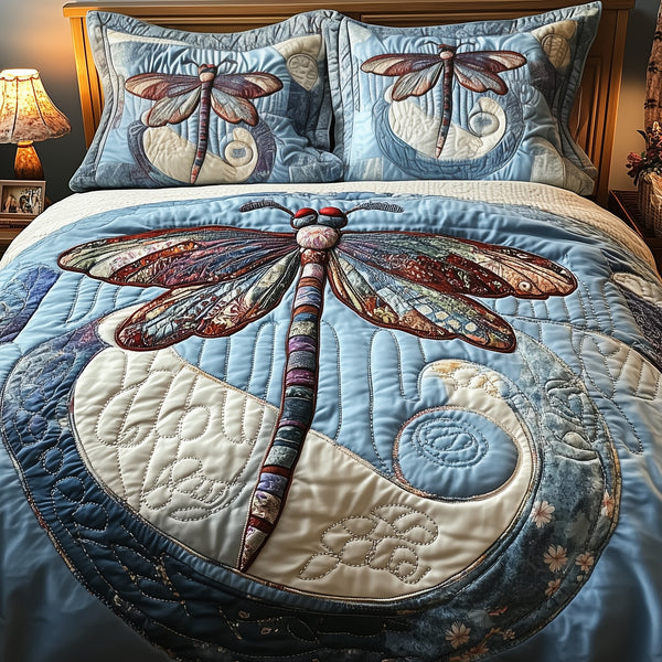 Elegant Dragonfly quilted 3-piece bedding set on a made bed with two matching pillow shams