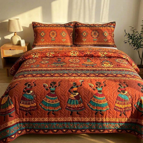 African Dancers quilted 3-piece bedding set on a made bed with two matching pillow shams