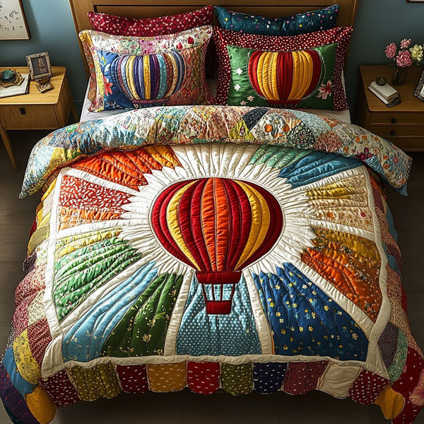 Airy Escapes quilted 3-piece bedding set on a made bed with two matching pillow shams