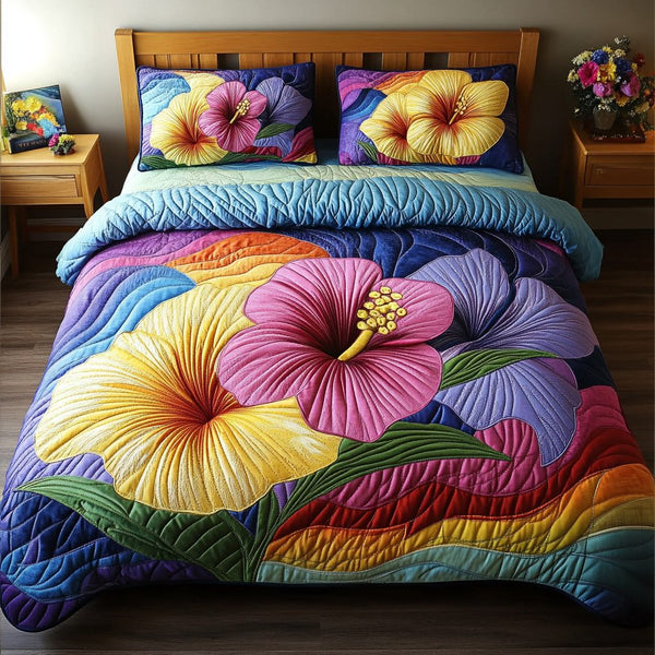 Aloha Blossom quilted 3-piece bedding set on a made bed with two matching pillow shams