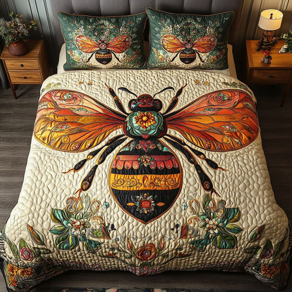 Amber Glow Bee quilted 3-piece bedding set on a made bed with two matching pillow shams