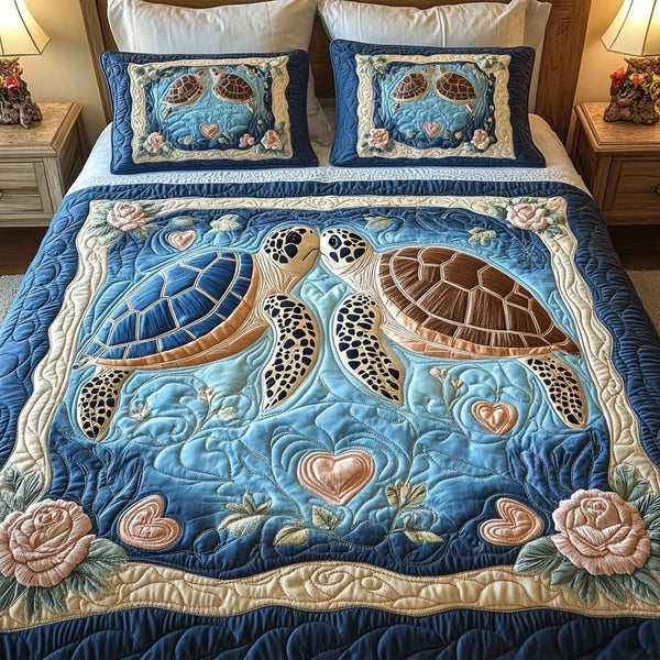 Aqua Love quilted 3-piece bedding set on a made bed with two matching pillow shams