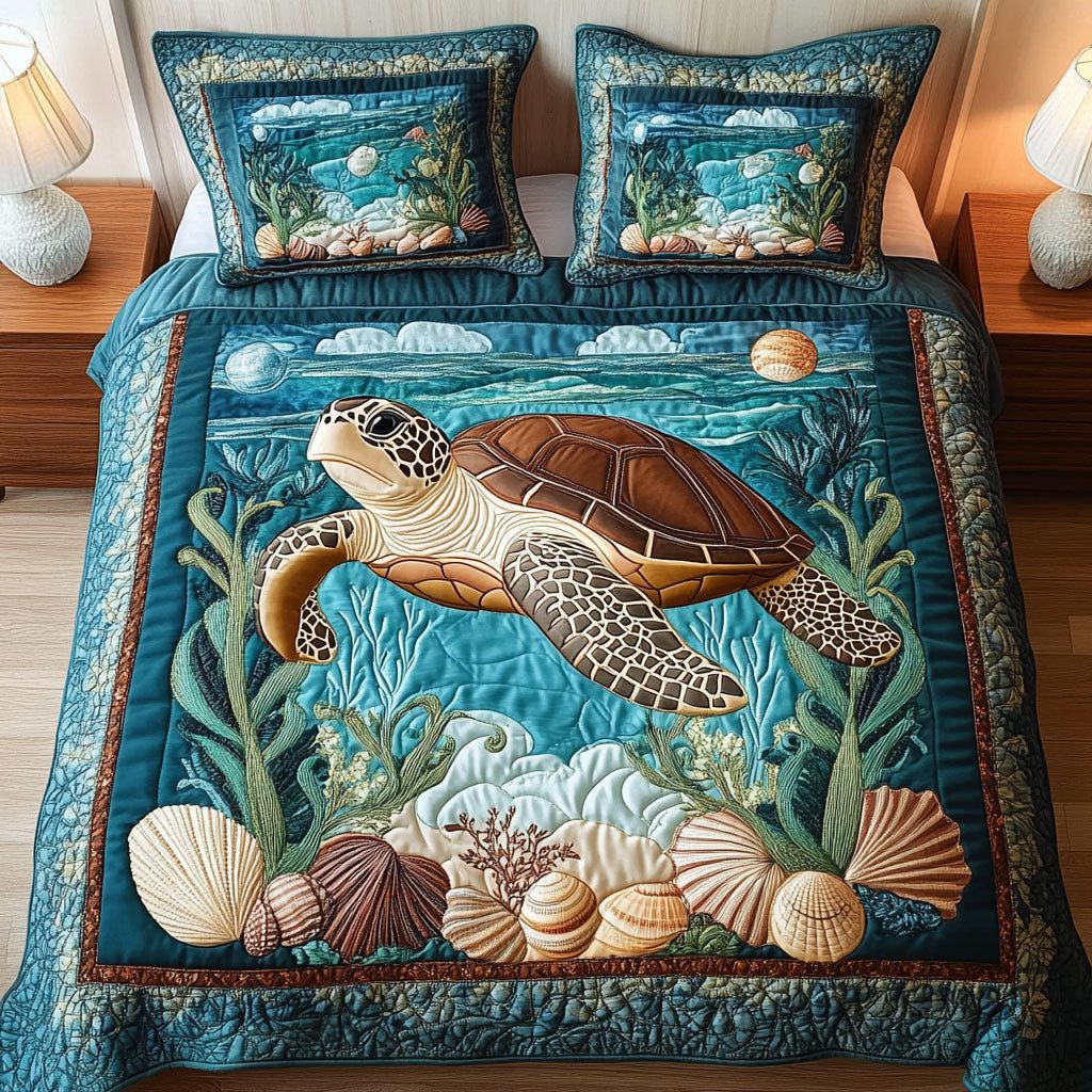 Aqua Voyager quilted 3-piece bedding set on a made bed with two matching pillow shams