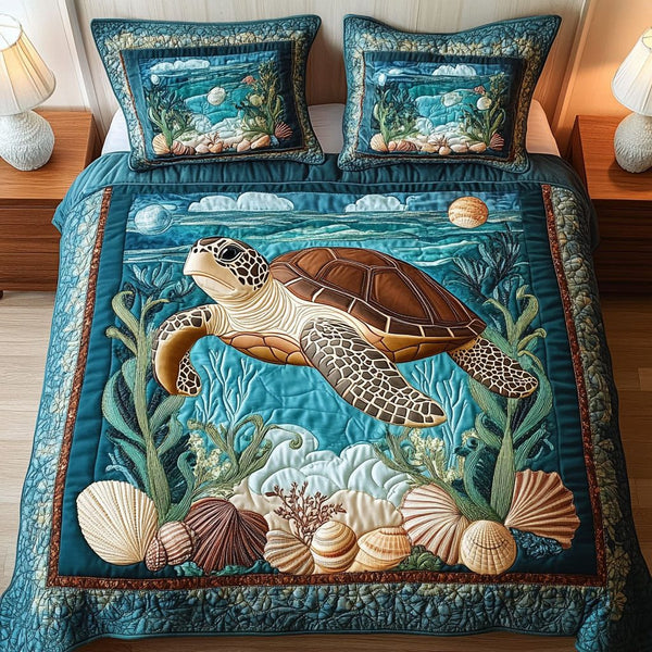 Aqua Voyager quilted 3-piece bedding set on a made bed with two matching pillow shams
