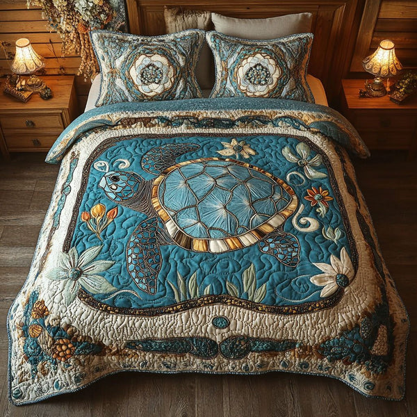 Aqua Wanderer quilted 3-piece bedding set on a made bed with two matching pillow shams