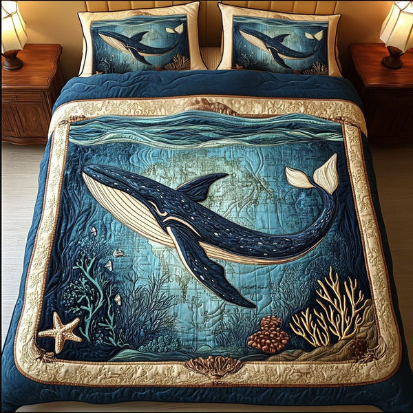 Aqua Whale Voyage quilted 3-piece bedding set on a made bed in a light coastal bedroom