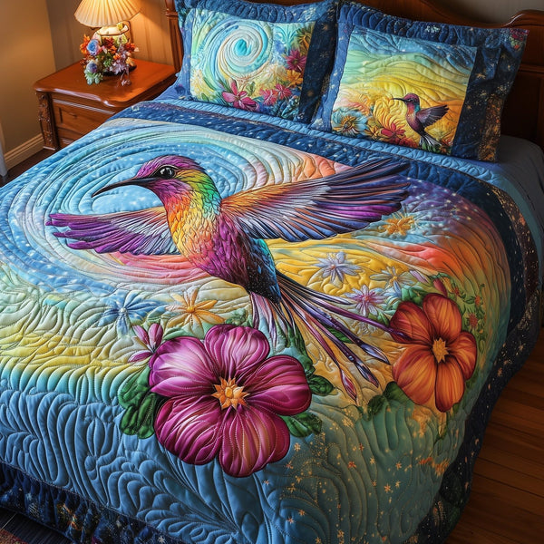 Aurora Hummingbird quilted 3-piece bedding set on a made bed with two matching pillow shams