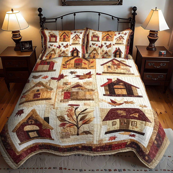 Autumn Bird House quilted 3-piece bedding set on a made bed with two matching pillow shams