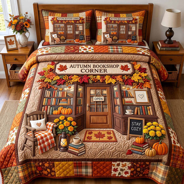 Autumn Bookshop quilted 3-piece bedding set on a made bed with two matching pillow shams