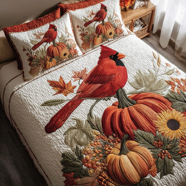 Autumn Cardinal quilted 3-piece bedding set on a made bed with two matching pillow shams