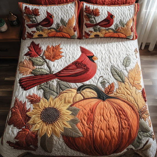 Autumn Cardinal quilted 3-piece bedding set on a made bed with two matching pillow shams