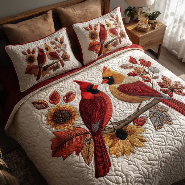 Autumn Cardinal quilted 3-piece bedding set on a made bed with two matching pillow shams