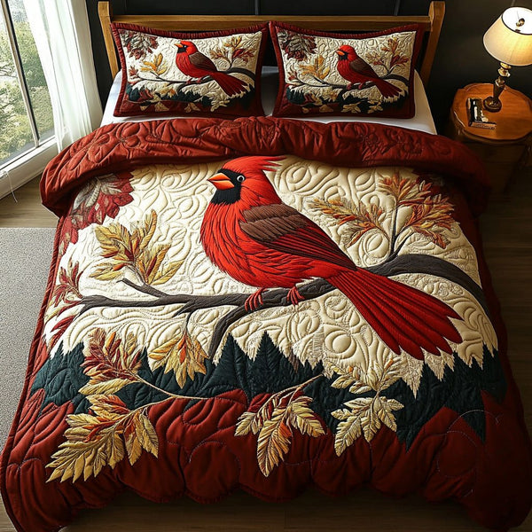 Autumn Cardinal quilted 3-piece bedding set on a made bed with two matching pillow shams
