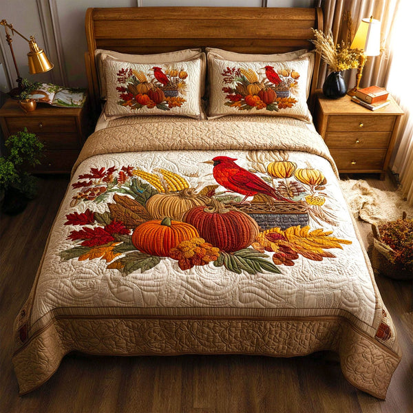 Autumn Cardinal quilted 3-piece bedding set on a made bed with two matching pillow shams