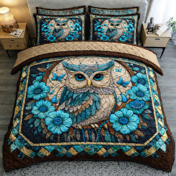 Azure Blossom Owl quilted 3-piece bedding set on a made bed with two matching pillow shams