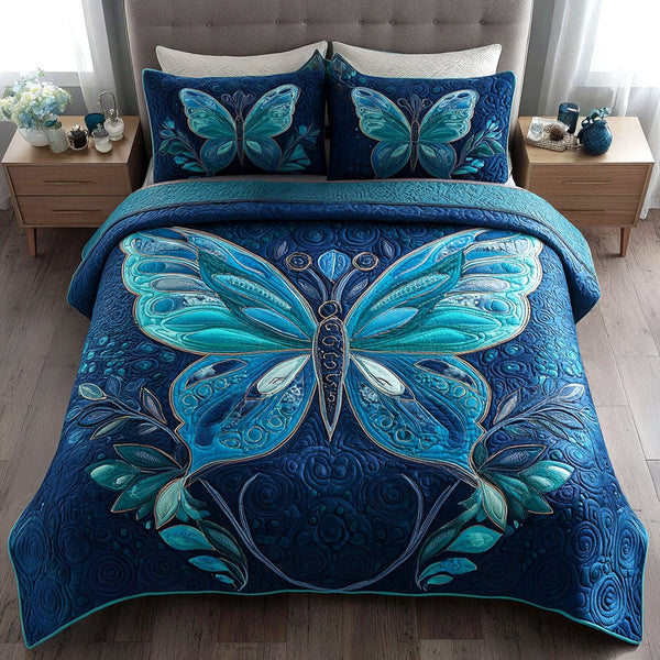 Azure Dreamwing quilted 3-piece bedding set on a made bed with two matching pillow shams