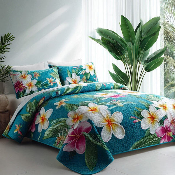 Azure Oasis quilted 3-piece bedding set on a made bed with two matching pillow shams
