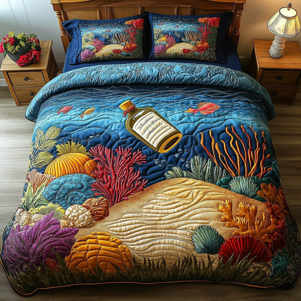 Beachfront Beauty quilted 3-piece bedding set on a made bed in a light coastal bedroom