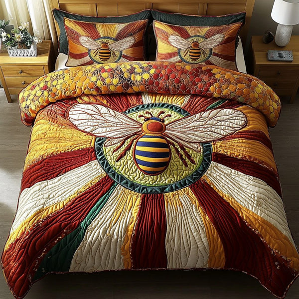 Bee Bliss quilted 3-piece bedding set on a made bed with two matching pillow shams