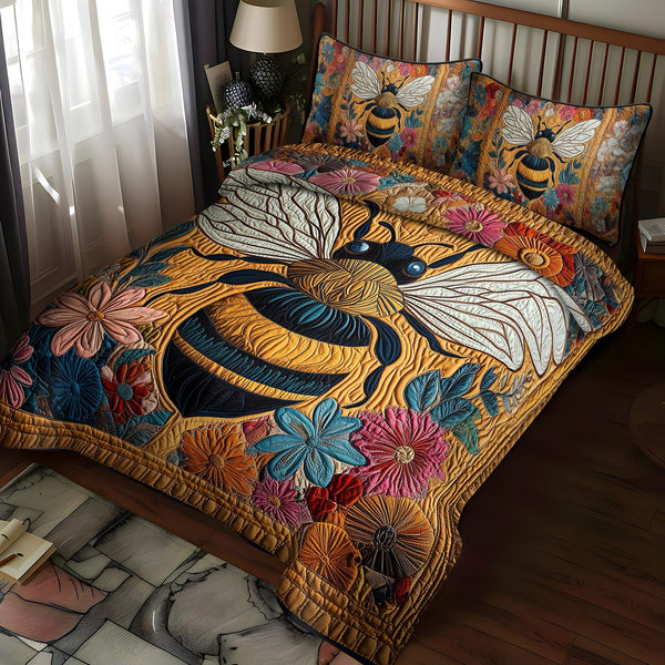Bee Bliss quilted 3-piece bedding set on a made bed with two matching pillow shams