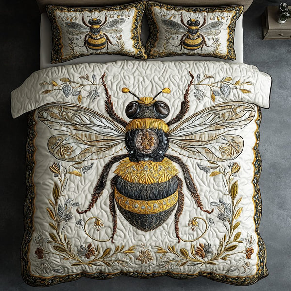 Bee Bliss quilted 3-piece bedding set on a made bed with two matching pillow shams